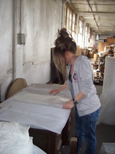 Image 3: Intern, Valia Goula, takes a break from labelling and listing objects by making bubble wrap and acid-free tissue cushions that will protect the objects during transport.