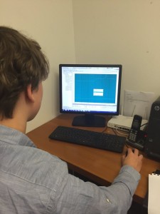 Luke using a computer, screen shows BMS system