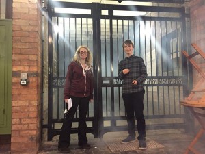 Luke and a member of cw staff stand in front of cw gates