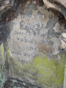 Headstone with hard to read engraved text