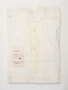 Folded white shroud with tag