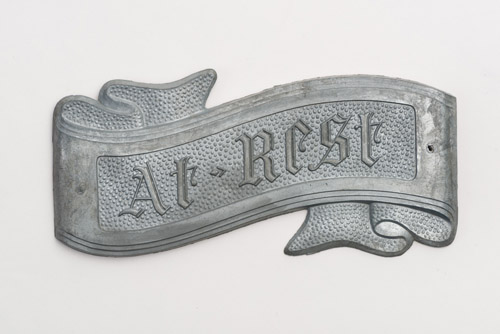 Zinc ribbon shapes coffin ornament with text "at rest"
