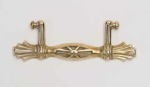 brass art deco handle with cut out shapes in the bar of handle