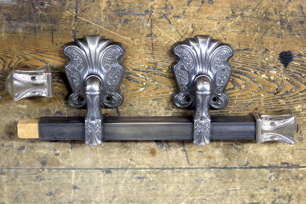 Dull silver coloured bar handle for a casket