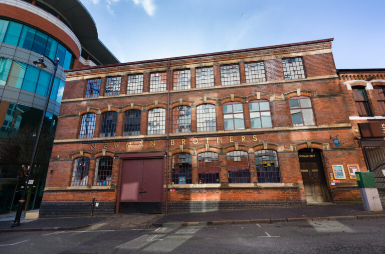 Front side of Newman Brothers building on a sunny day