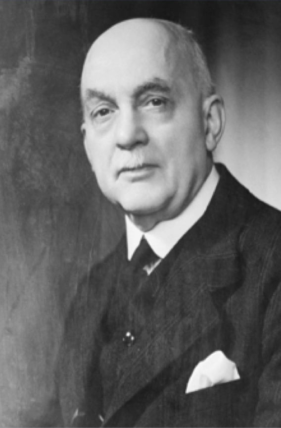 Black and white image of bald man in suit