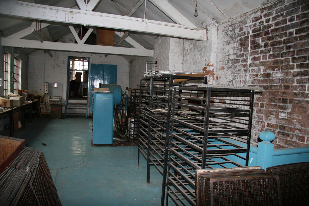 Vacuum Coating Shop, blue floor with freestanding shelves towards the front of image