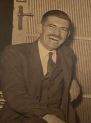 black and white image of Dai Davies laughind