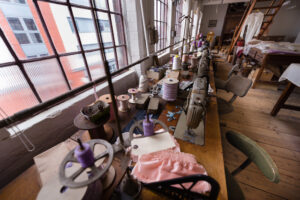 The Shroud Room, sewing machines in front of windows