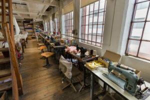 The Shroud Room, sewing machines on tables in front of windows