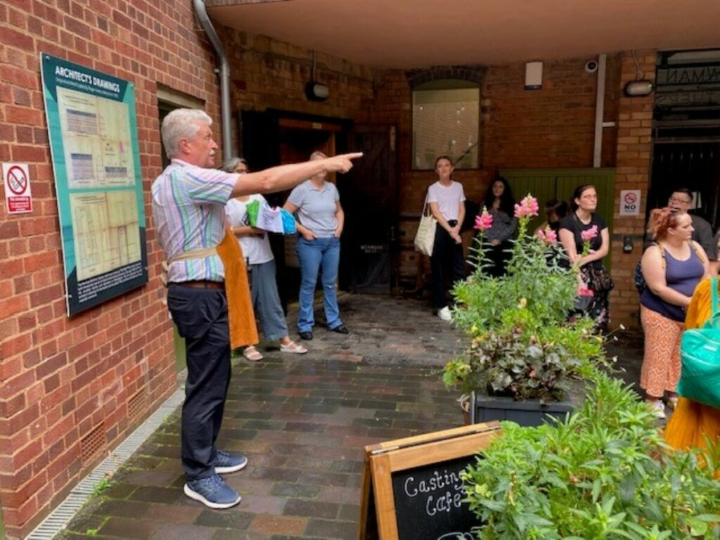 Man leading tour at Coffin Works