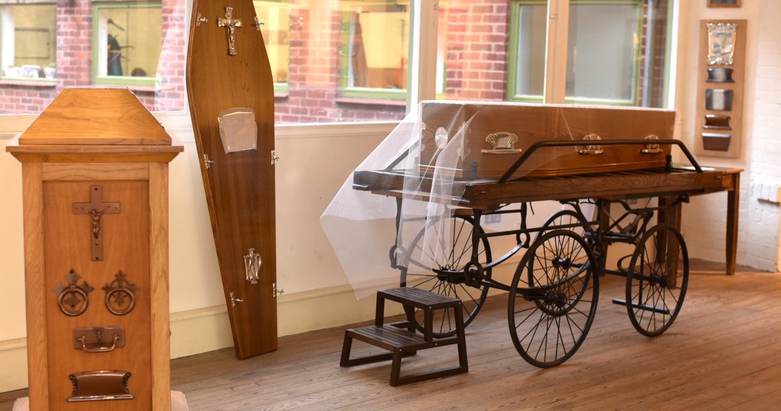 Coffin and coffin furniture on the first floor of the building.