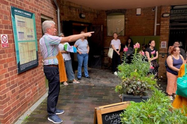 Man leading tour at Coffin Works