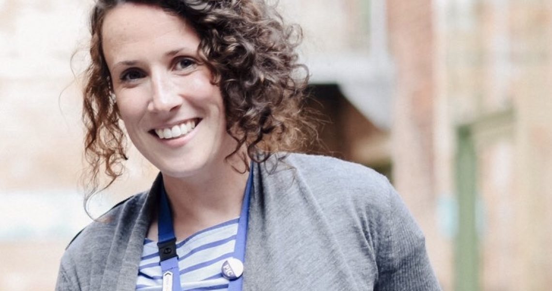 Sarah Hayes smiling, standing in Coffin Works courtyard.